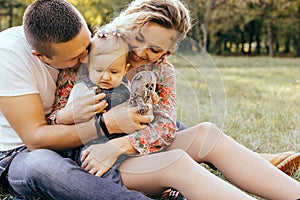 Happy family father, mother and child daughter outdoor  enjoying  sunset  - Image