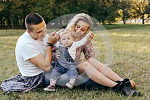 Happy family father, mother and child daughter outdoor  enjoying  sunset  - Image