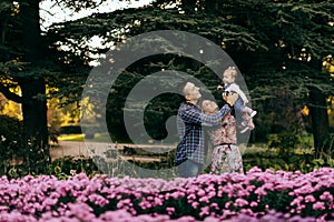 Happy family father, mother and child daughter outdoor  enjoying  sunset  - Image