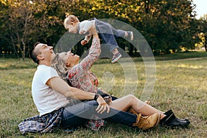 Happy family father, mother and child daughter outdoor  enjoying  sunset  - Image