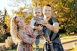 Happy family father, mother and child daughter outdoor  enjoying  sunset  - Image