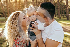 Happy family father, mother and child daughter outdoor  enjoying  sunset  - Image