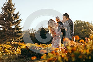 Happy family father, mother and child daughter outdoor  enjoying  sunset - Image