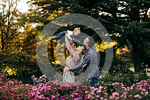 Happy family father, mother and child daughter outdoor  enjoying  sunset  - Image