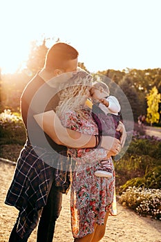 Happy family father, mother and child daughter outdoor  enjoying  sunset  - Image