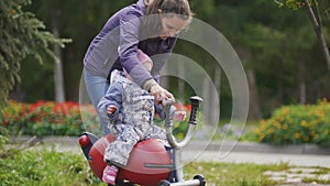 Happy family: Father, Mother and child - little girl walking in autumn park: mammy and baby playing at playground