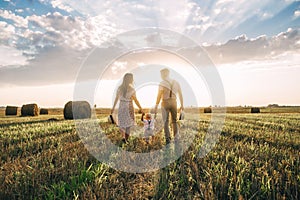 Happy family father of mother and child son on nature at sunset