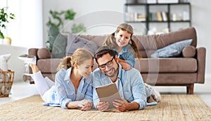 Happy family. father, mother and child with tablet computer at home