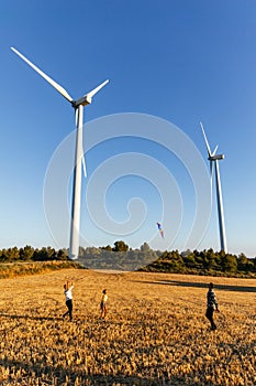 Happy family of father, mother and daughter launch a kite in nature on a summer day.