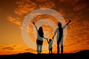 Happy family father mother and son playing outdoors at sunset si