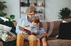 Happy family. father reading a book to a child daughter at home   happy family