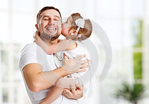 Happy family and father's day. daughter kissing and hugging dad