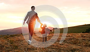 Happy family father and son in nature at sunset