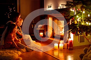 Happy family by a fireplace on Christmas