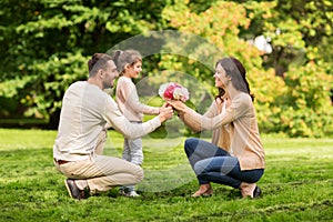 Happy family with flowers in summer park