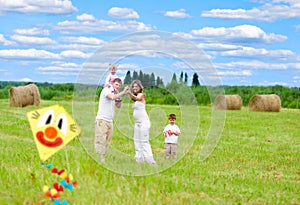 Happy family fly kite summertime