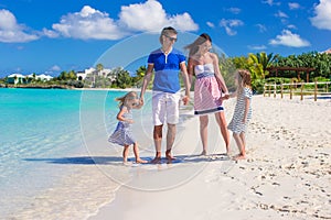 Happy family of four on beach vacation