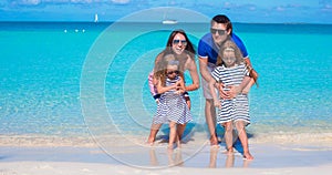 Happy family of four on beach vacation