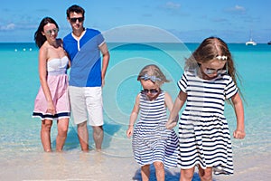 Happy family of four during beach vacation