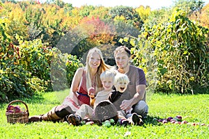 Happy Family of Four Having Fruit Snack at Autumn Apple Orchard