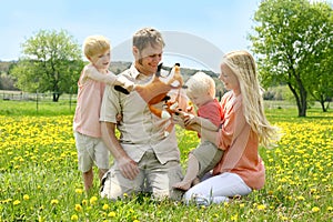 Happy Family of Four People Playing with Toys Outside in Flower