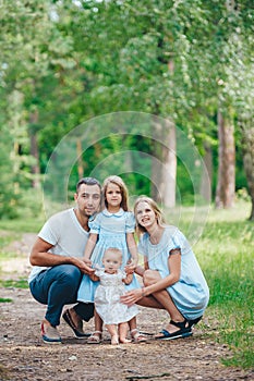 Happy family of four persons outdoors. Family portrait