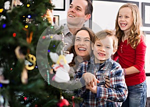 Happy family of four preparing for Christmas