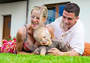 Happy family in front of the house