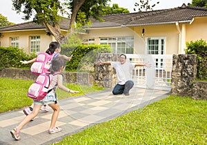 Happy family in front of house