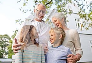 Happy family in front of house outdoors