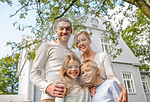 Happy family in front of house outdoors