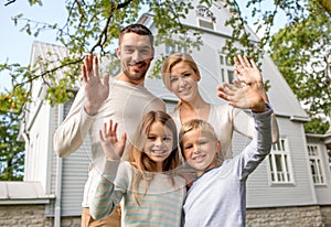 Happy family in front of house outdoors