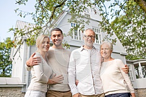 Happy family in front of house outdoors