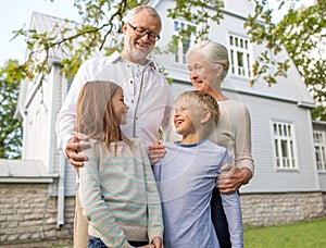 Happy family in front of house outdoors