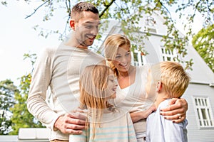 Happy family in front of house outdoors