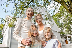 Happy family in front of house outdoors