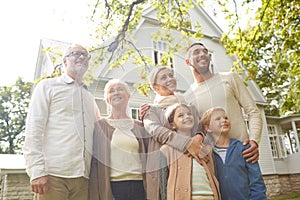 Happy family in front of house outdoors