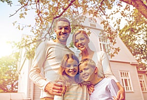 Happy family in front of house outdoors