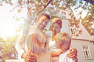 Happy family in front of house outdoors