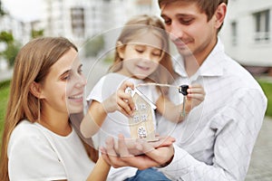 Happy family in front of new apartment building