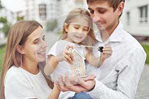 Happy family in front of new apartment building