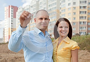 Happy family in front of new home