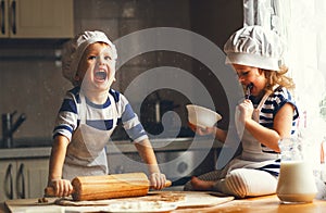 Happy family funny kids bake cookies in kitchen