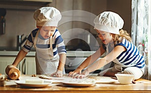 Happy family funny kids bake cookies in kitchen