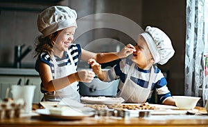 Happy family funny kids bake cookies in kitchen