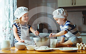 Happy family funny kids bake cookies in kitchen