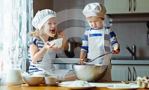 Happy family funny kids bake cookies in kitchen