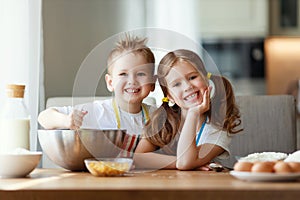 Happy family funny kids bake cookies in kitchen