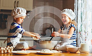 Happy family funny kids bake cookies in kitchen