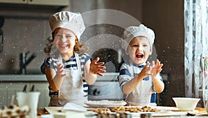Happy family funny kids bake cookies in kitchen